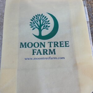 Moon Tree Farm reusable tote bag with green logo and website printed on the front